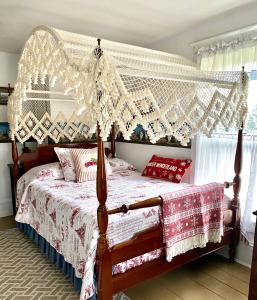 a bedroom with a bed with a canopy at The Bella Ella Bed and Breakfast in Canandaigua