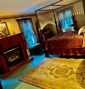 a bedroom with a bed and a fireplace and a rug at The Bella Ella Bed and Breakfast in Canandaigua