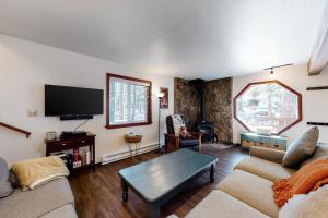 a living room with a couch and a tv at Truckee Mountain Retreat in Truckee
