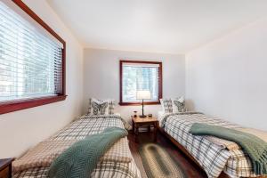 two twin beds in a room with a window at Truckee Mountain Retreat in Truckee +21 photos