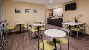 a restaurant with tables and chairs and a counter at SureStay Hotel by Best Western Fairfield Napa Valley in Fairfield
