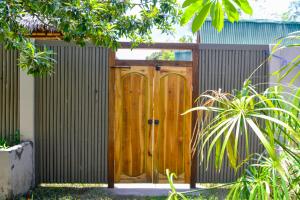 a wooden door in a fence at H2O Peaceful Yoga Resort in Gili Air