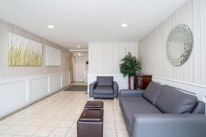 a living room with a couch and two chairs at Sandman Inn Kamloops in Kamloops