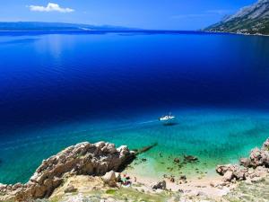 a boat in a large body of water at Rooms Jakirusa in Brela +10 photos