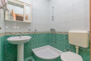 a bathroom with a toilet and a sink at Apartment Ivan in Brela