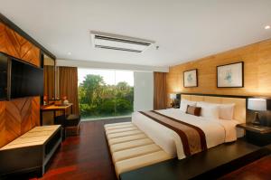 Postel nebo postele na pokoji v ubytování de Vins Sky Hotel Seminyak