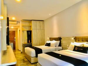 Postel nebo postele na pokoji v ubytování Graha Socio Hotel Nusa Dua Bali