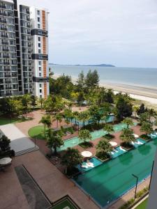 an aerial view of a resort with a pool and the beach at Studio with Privacy Balcony and NETFLIX at TimurBay Sea Front Residence in Kuantan