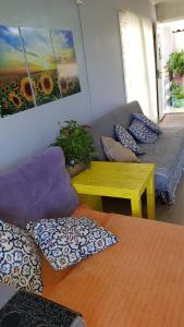 a living room with a couch and a table with pillows at Casa Deni in Nova Petrópolis