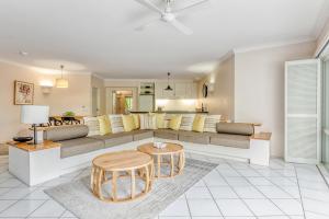 a living room with a couch and a table at Alamanda Resort Private Apartments in Palm Cove