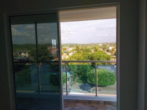 an open window with a view of a city at Apartahotel Sueños Libres Necoclí in Necoclí