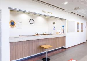a counter in a hospital with a clock on the wall at SAIDAIJI GRAND HOTEL - Vacation STAY 67891v in Setouchi
