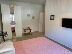 a bedroom with a bed and a tv and a chair at The View Condo No2 'The Emmanuel' in Kyra Panagia