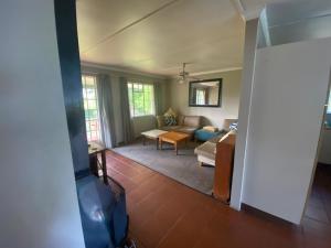 a living room with a couch and a table at Under The Oak in Underberg
