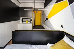 a bedroom with a bed and a yellow door at Greenfeel Novgorod in Velikiy Novgorod