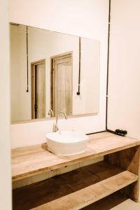 a bathroom with a sink and a mirror at LoTide Surf Camps Lombok in Kuta Lombok