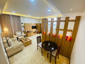 a living room with a table and a couch at S R Continental in Gulbarga