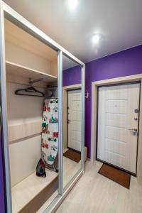 a walk in closet with a sliding glass door at "Sharm" Стильная студия на Броско in Khabarovsk