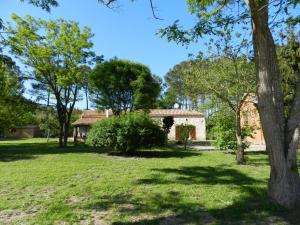 a house in a park with trees and grass at Chambres d'Hôtes L'Hermitage in Anzex