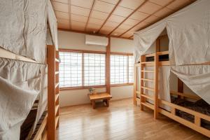 Postel nebo postele na pokoji v ubytování Guest House Takazuri-KITA