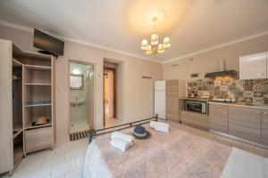 a large room with a large bed and a kitchen at Minas Apartments in Divarata +37 photos