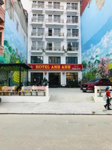 a person walking in front of a hotel entrance at ANH ANH HOTEL in Bắc Hà