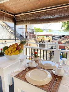 a table with plates of food on a balcony at Beach Walk Hotel Unawatuna in Unawatuna