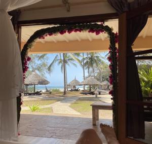 an open door to a resort with a view of the beach at Eleven Pearl Boutique Hotel & Spa in Diani Beach