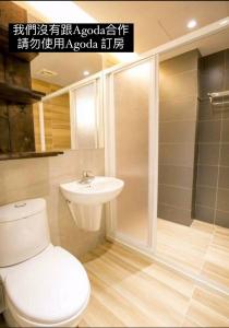 a bathroom with a toilet and a sink at Original Bnb in Tainan