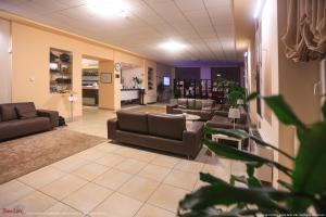 a waiting room with couches and chairs in a lobby at Sirio Life Hotel in Trissino