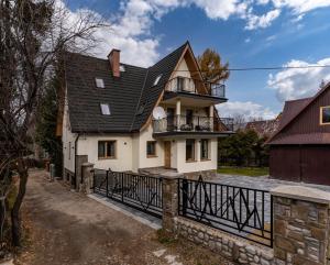 a house with a black roof at Villa 7 Apartments in Zakopane