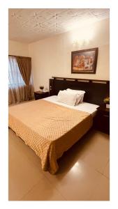 a bedroom with a large bed with at Indigo Hotel in Lagos