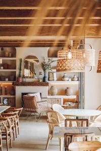 a dining room with white tables and chairs at Nomad Hotel - Xábia Port in Jávea