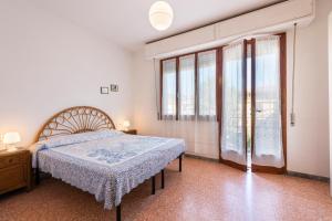 una camera da letto con un letto e una grande finestra di Suite Daniela 3 by MMega a Massa