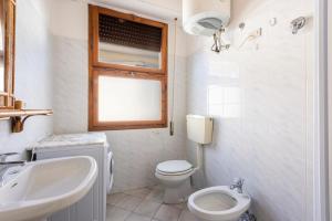 un bagno bianco con un water e un lavandino di Suite Daniela 3 by MMega a Massa Altre 15 foto