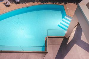 an overhead view of a swimming pool in a building at Gelso Bianco Apartments in Campofelice di Roccella