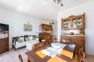 a living room with a table and a couch at Piso Livadi Paros seafront holiday home Casa Alena in Kampos Paros