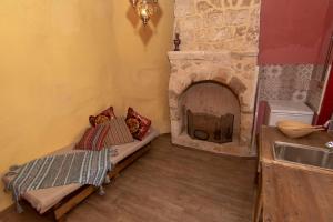 a kitchen with a stone fireplace in a room at Fatma Hanoum boutique hotel in Rhodes Town