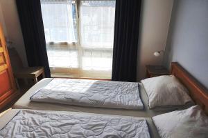 a bedroom with two beds in front of a window at Dünenblick Wohnung 47 in Boltenhagen