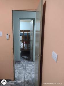 a hallway with a door leading into a room at jazmin apart iguazu in Puerto Iguazú