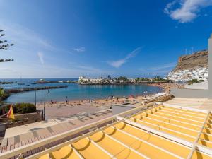 a view of a beach with people in the water at FIRST LINE MOGAN BEACH - Parking free in Mogán
