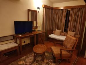 a living room with a television and a couch at Langkawi Lagoon Hotel Resort in Kampung Padang Masirat