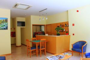 a kitchen and dining room with a table and chairs at Hotel Caldelas in Caldelas