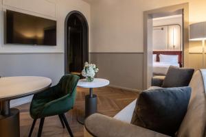 a hotel room with a bed and a table and chairs at Luxury Apartments Palazzo Nani in Venice