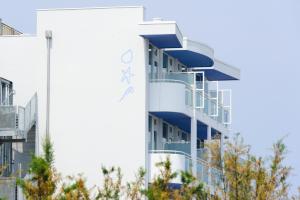 a building with a sign on the side of it at Hotel Mediterraneo in Sottomarina