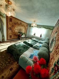 a bedroom with a large bed with red flowers on it at Guesthouse Kishimzhan in Talas