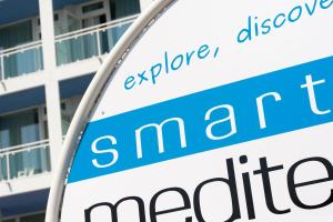 a sign in front of a building at Hotel Mediterraneo in Sottomarina
