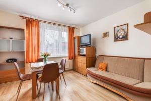 a living room with a couch and a table at Apartamenty przy Promenadzie by Renters in Świnoujście