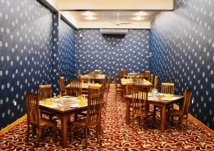 a dining room with tables and chairs and blue walls at Hotel Summer Haven in Polonnaruwa