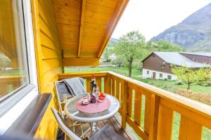 a table and chairs on a balcony with a view at Flåm Holiday House in Flåm